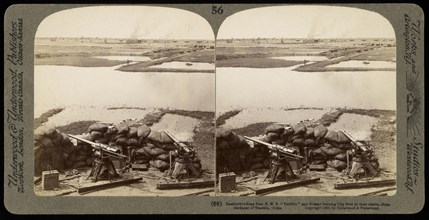 Destructive guns from H.M.S. 'Terrible' and distant burning city fired by their shells, Ricalton, James, Underwood and Underwood