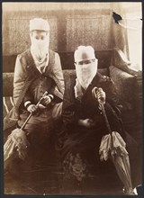 Two veiled women, seated with parasols, photographs of the Ottoman Empire