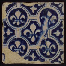 Two-tone tile, blue on white background, painting finished, four circles with white French lily around central ornament