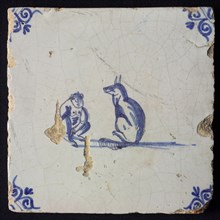 Animal tile, sitting monkey and dog looking at each other, in blue on white, corner pattern ox head, wall tile tile sculpture