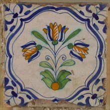 Tile, mounted in wax, three-tier in blue, green and orange on white, inside frame with accolades, corner motif, wing, wall tile