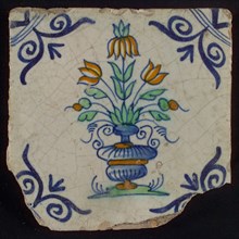 Tile, three-tier in blue, green, orange and purple on white, inside frame with accolades, corner motif, wing, wall tile
