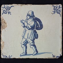Occupation tile, blue with man with hat and bag over the shoulder, corner pattern ox-head, wall tile tile sculpture ceramic