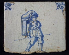 Occupation tile, blue with man with hat and basket on the back, bag carrier, corner motif oxen head, wall tile tile sculpture