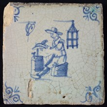 Occupation tile, blue with an anvil blacksmith, corner motif ox head, tile has iridescent patina, wall tile tile sculpture