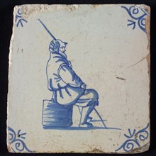 Occupation tile, blue with man sitting on block or shepherd with staff, corner pattern ox-head, wall tile tile sculpture ceramic