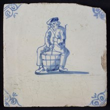 Occupation tile, blue with seated man, movable or churning in barrel, corner motif oxen head, wall tile tile sculpture ceramic