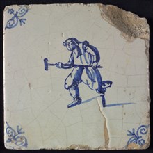 Figure tile, blue with man with wooden leg and stool, in attacking position, corner pattern ox head, wall tile tile sculpture