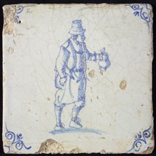 Figure tile, blue with standing man with beer jug, corner motif oxen head, wall tile tile sculpture ceramic earthenware glaze