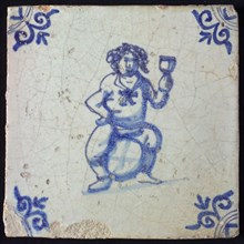 Figure tile, blue with fat man sitting on barrel with raised wineglass, probably Bacchus, corner motif ox's head, wall tile