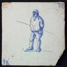 Figure tile, blue with standing man with staff under the arm, corner motif ox's head, wall tile tile sculpture ceramic