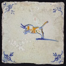 Animal tile, attacking bull to the left, blue and brown on white, corner motif ox's head, wrinkled glaze, wall tile
