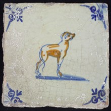 Animal tile, greyhound looking up to the right, in blue and brown on white, corner motif oxen head, wall tile tile sculpture