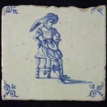 Figure tile, blue with man leaning on stool, big hat with plume, corner pattern ox head, wall tile tile sculpture ceramic