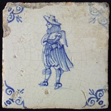 Figure tile, blue with nobleman with wide cape, breeches and big hat, corner pattern ox's head, wall tile tile sculpture ceramic