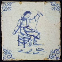 Occupation tile, blue with seated cobbler, corner motif of ox's head, wall tile tile sculpture ceramic earthenware glaze wood