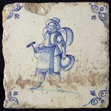Occupation tile, blue with standing coppersmith with hammer and several pots, corner motif of ox's head, wall tile