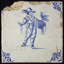 Occupation tile, blue with hawker with coffin with merchandise and plumes in one hand, corner motif oxen head, wall tile