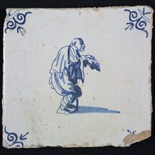 Figure tile, blue with curving figure with handle, beggar, corner motif of ox's head, wall tile tile sculpture ceramic