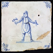Figure tile, blue with man with pickaxe in one hand and in the other an unknown object, corner pattern ox's head, wall tile