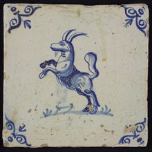 Animal tile, jumping goat to the left on piece of ground, in blue on white, corner patterned ox-head, wall tile tile sculpture