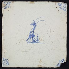 Animal tile, sitting giraffe to the left, in blue on white, corner motif ox's head, wall tile tile sculpture ceramic earthenware