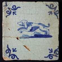 Animal tile, jumping dog to the left on ground, in blue on white, corner motif oxen head, wall tile tile sculpture ceramic