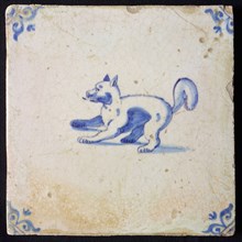 Animal tile, standing dog to the left, in blue on white, corner motif ox's head, wall tile tile sculpture ceramic earthenware