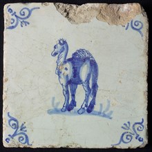 Animal tile, standing dromedary to the left on ground, in blue on white, corner pattern ox head, wall tile tile sculpture