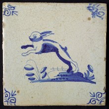 Animal tile, jumping hare left on ground, in blue on white, corner pattern ox head, wall tile tile sculpture ceramic earthenware