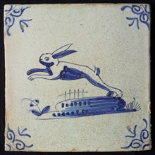 Animal tile, jumping hare to the left on ground, in blue on white, corner pattern ox head, wall tile tile sculpture ceramic
