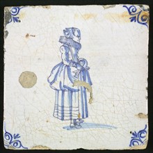 Figure tile, blue with lady with millstone collar and drawn overcoat, corner motif of ox's head, wall tile tile sculpture