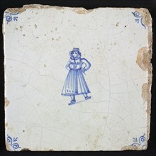 Figure tile, blue with woman with laced straitjacket, corner pattern ossenkop, wall tile tile sculpture ceramic earthenware