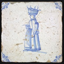 Figure tile, blue with woman with basket fish on the head, corner motif oxen head, wall tile tile sculpture ceramic earthenware