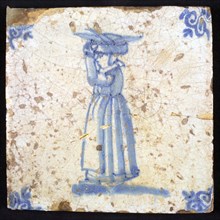 Figure tile, blue with woman with basket with fish on the head, corner pattern ox's head, wall tile tile sculpture ceramic