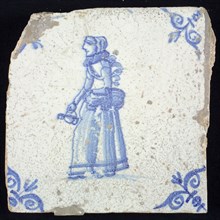 Figure tile, blue with jug with basket at the hip, corner motif oxen head, wall tile tile sculpture ceramic earthenware glaze