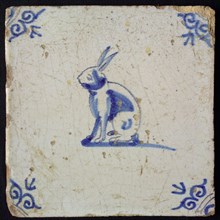 Animal tile, sitting hare to the left, in blue on white, corner motif oxen head, wall tile tile sculpture ceramic earthenware
