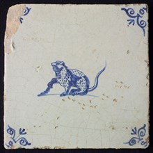 Animal tile, sitting panther to the left, in blue on white, corner patterned ox-head, wall tile tile sculpture ceramic