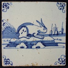 Animal tile, sitting hare to the right on continuous ground, three sailing ships in the background, in blue on white, corner