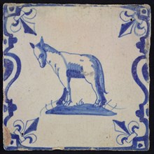 Animal tile, standing horse to the left on plot between balusters, in blue on white, corner pattern French lily, wall tile