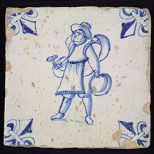 Figure tile, blue with brazier, man with hammer and various pots on the arms, corner motif lily, wall tile tile sculpture