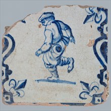 Figure tile, blue with peasant in progress, between balusters with lily, wall tile tile sculpture ceramic earthenware glaze