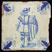 Figure tile, blue with nobleman with cloak over the shoulder, lace collar, big hat, corner motif, wall tile tile sculpture