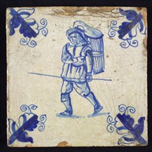 Figure tile, blue with walking man with basket or basket on the back and staff in the hand, corner motif, wall tile