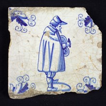 Figure tile, blue with standing nobleman with an unknown object in the hands, corner motif wader, wall tile tile sculpture