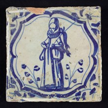 Figure tile, blue with hunting scene with woman with staff with dead rabbit, curly braces with corner motif, wall tile