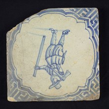 Figure tile, blue with carpenter with an ax and lath in hands, in scalloped frame with accolades, corner motif meander, wall