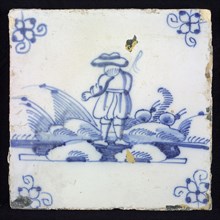 Figure tile, blue with landscape with standing shepherd seen on the back, corner pattern spider, wall tile tile sculpture