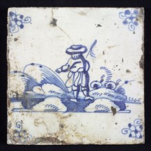 Figure tile, blue with landscape with standing shepherd seen on the back, corner pattern spider, wall tile tile sculpture
