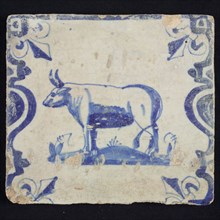 Animal tile, standing ox or cow to the left on plot between balusters, in blue on white, corner pattern French lily, wall tile